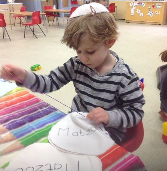 rows of menorahs or chanukiahs made of clay to celebrate hanukah at woodside gan nursery