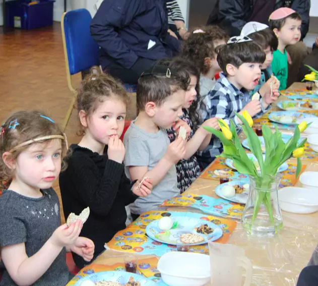 rows of menorahs or chanukiahs made of clay to celebrate hanukah at woodside gan nursery